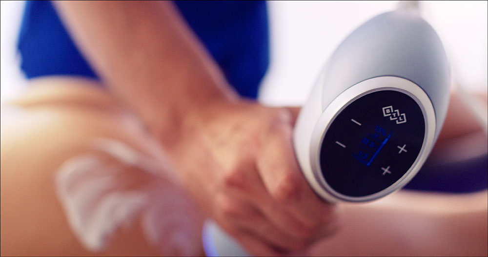 Handheld device treating the skin of an arm at our Chelsea clinic, EMtone cellulite reduction London